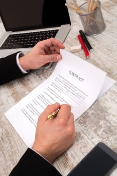 A businessman reading a Contract before signing.