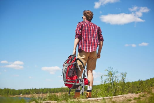 Young traveler with rucksack enjoying trip