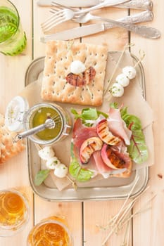 Sandwich with raw ham,grilled peaches and mozzarella
