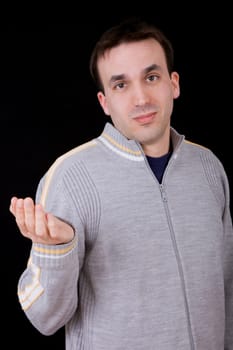 young casual man thinking on black background