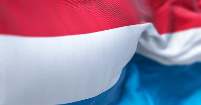 Close-up view of the Luxembourg national flag waving. The Grand Duchy of Luxembourg is a landlocked country in Western Europe. Fabric textured background. Selective focus. 3D illustration