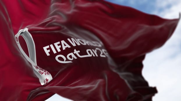 Doha, QA, October 2022. Close-up view of the FIFA Qatar 2022 World Cup flag waving in the wind. The World Cup will take place in Qatar from 20 November to 18 December 2022