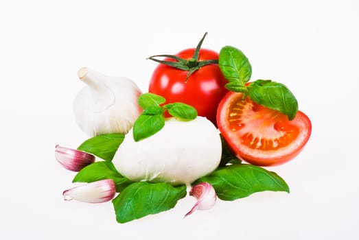 Bunch of tomatoes with mozzarella, garlic and basil