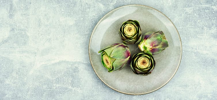 Uncooked unopened artichoke buds, food. Italian cuisine
