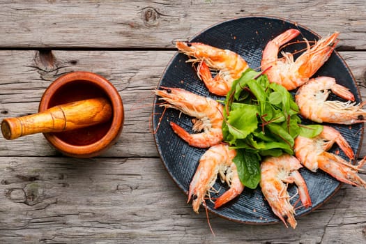 Appetizing cooked grilled shrimp on wooden skewers.