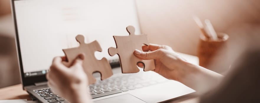 Woman holding pieces of puzzle in the office. Concept of solving problems and working together in company.