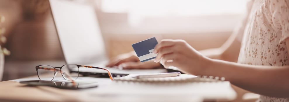 Woman at office trying to moke e-pay. Concept of e-commerce and office at home.