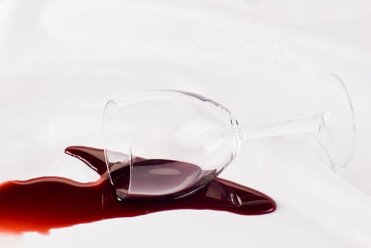 Glass of wine overthrow on the table cloth