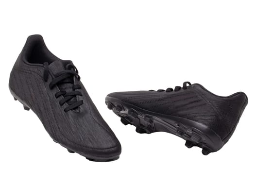 Closeup of a pair of black leather football boots isolated on white background. Professional athletics boys outdoor training shoes. Sports shoes.