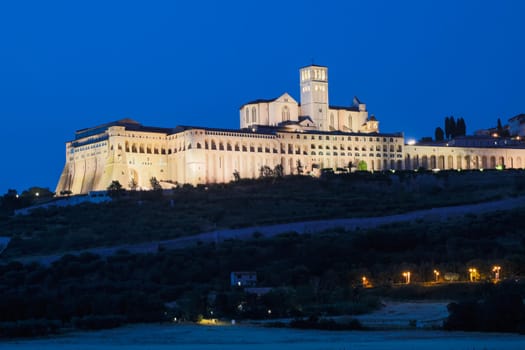 Assisi Basilica by night in Umbria region, Italy. The town is famous for the most important Italian St. Francis Basilica (Basilica di San Francesco)