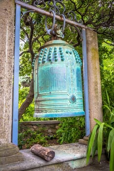 VENTIMIGLIA, ITALY - CIRCA AUGUST 2020: old Japanese bell located in Hambury Gardens and finely crafted in bronze. It seems to come from a Buddhist shrine destroyed by a fire in central Japan.