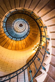 Penmarch, France - August, 11 2017 : Vertical view of spiral staircase inside the Eckmuhl lighthouse in Brittany, France