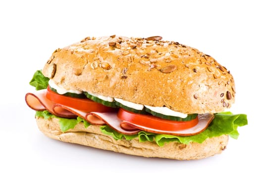 Freshly made sandwich with ham and vegetables over white