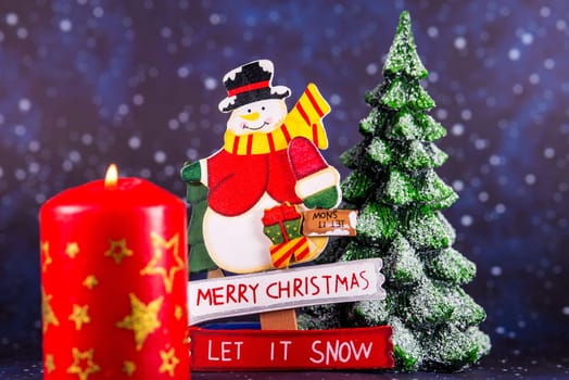 burning candle with Santa Claus in the background