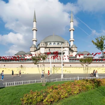 Istanbul, Turkey - September 2 2022: Tourists and locals walking in front of Taksim Mosque, at Taksim Square, Beyoglu district, central Istanbul, in a sunny summer day