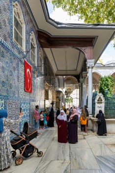 Istanbul, Turkey - September 1 2022: People praying in front of the tomb of Abu Ayyub al-Ansari at Eyup Sultan Mosque
