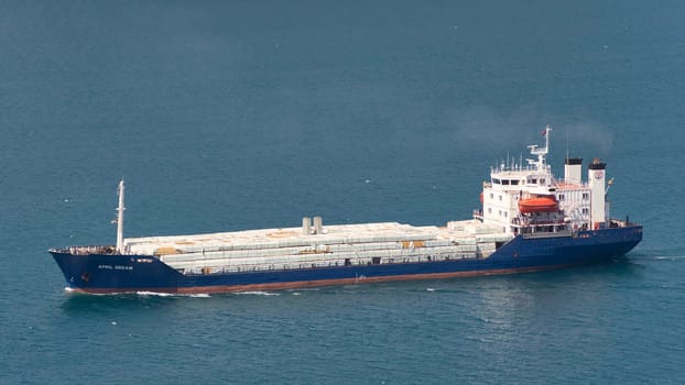Loaded cargo ship named APRIL DREAM passing Bosporus Strait in a summer day, Istanbul, Turkey