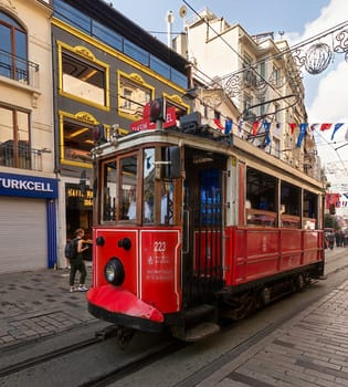 Istanbul, Turkey - September 2 2022: Nostalgic Taksim Tunel Red Tram, or tramvay, at Istiklal Street, Beyoglu district, central Istanbul, in a sunny summer day
