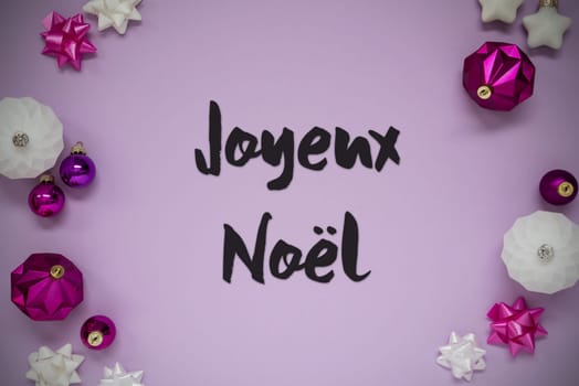 Christmas Card With French Text Joyeux Noel Means Merry Christmas. Purple Christmas Background With Romantic And Brilliant Decoration Like Balls.