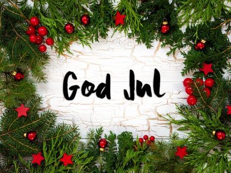 Christmas Card With Fir Branches And Swedish Text God Jul Means Merry Christmas. White Wooden Background With Vintage Design And Christmas Decoration Like Red Ornament Balls.