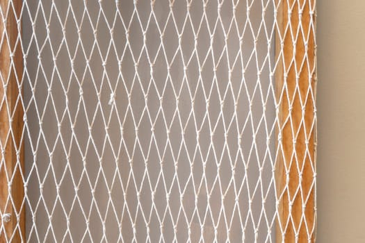 White mesh and wood and concrete wall background