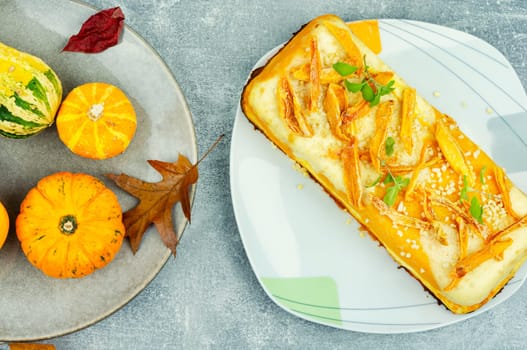 Homemade cakes, autumn recipe. Cottage cheese pumpkin casserole decorated with orange peels.