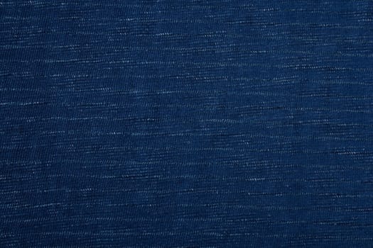 Blue fabric with light white stripes. Blue background.