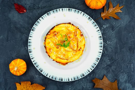 Homemade cakes, autumn recipe. Cottage cheese pumpkin casserole decorated with orange peels.