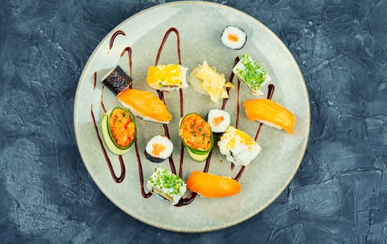 Appetizing colorful sushi rolls on the plate. Sushi menu. Japanese food.