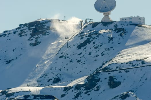 View of the ski resort in the high snowy mountains next to the astronomical observatory, listening in the cosmos