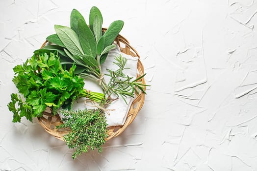 Bouquets of fresh garden culinary plants of rosemary, thyme, parsley and sage. Fresh herbs for cooking healthy meal or natural health care