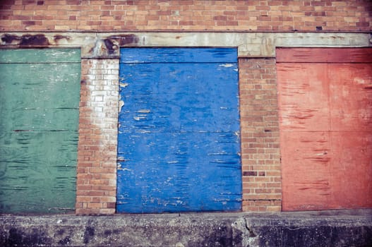 Weathered colored wood planks with peeling paint