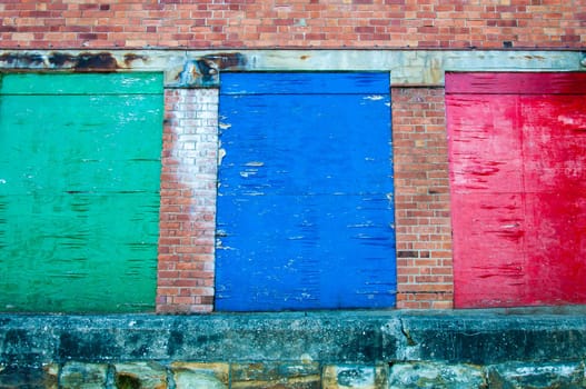 Weathered colored wood planks with peeling paint