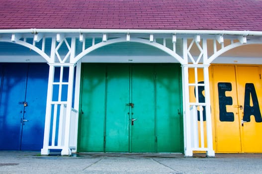View of Bright colored beach huts on summer day