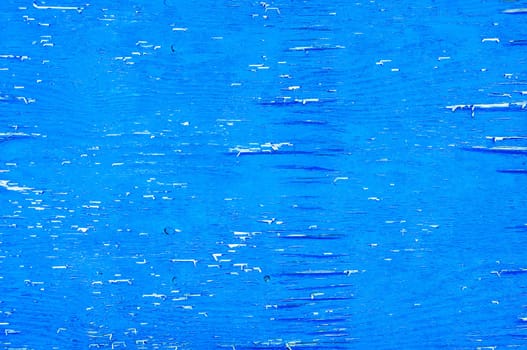 Weathered blue wood with peeling paint