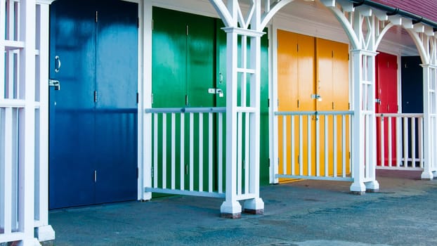 View of Bright colored beach huts on summer day