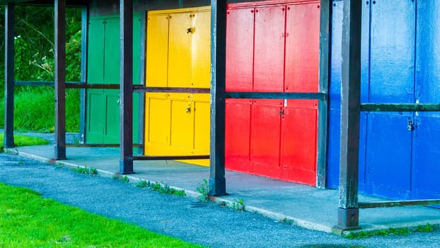 View of Bright colored beach huts on summer day