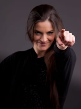 A long-haired beautiful woman pointing out her finger