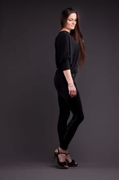 A long-haired beautiful self-confident woman posing