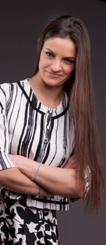 A long-haired beautiful self-confident woman posing