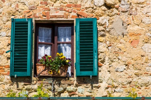view from a window of an old house in a Tuscan village