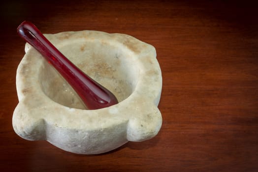 Ancient Marble mortar on a wood table