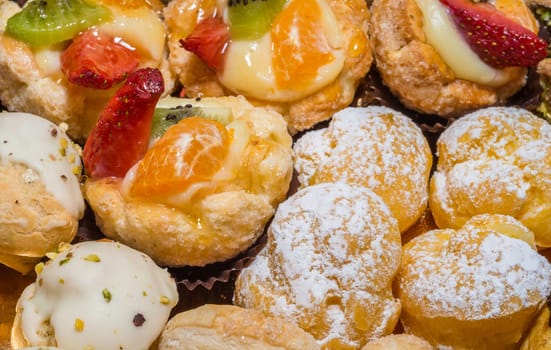 colorful pastries with fruits, cream and chocolate, the real Italian confectionery