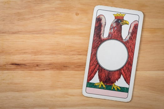 Dinar ace italian card on a wood background