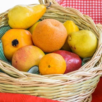 Oranges, apples and pears in a wicker basket