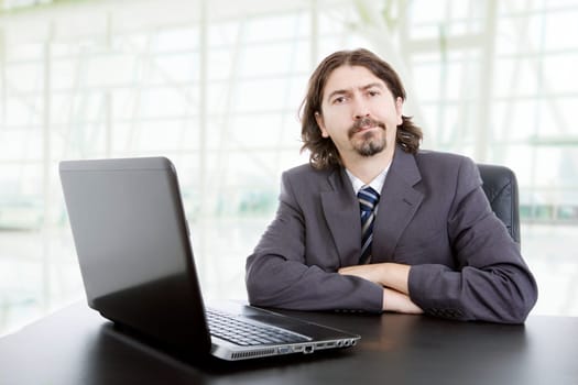 young business man working with is laptop, at the office