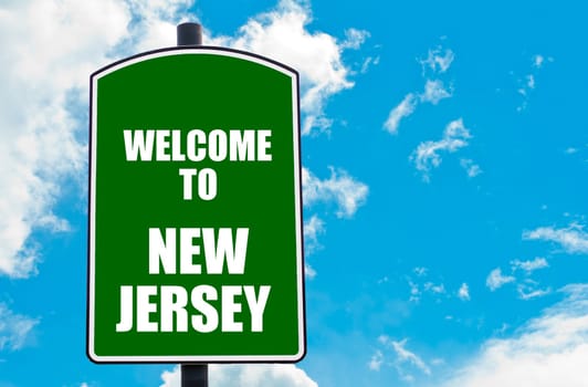Green road sign with greeting message WELCOME TO ORLANDO isolated over clear blue sky background with available copy space. Travel destination concept  image