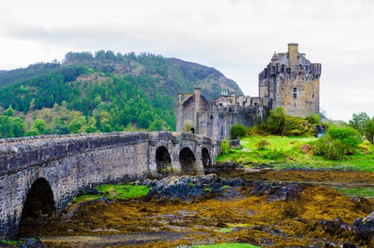 Famous Eilean Donan Castle in Scotland, UK. Situated on a small isle at the meeting point of three sea lochs - Loch Long, Loch Duich and Loch Alsh, is one of the most iconic images of Scotland.