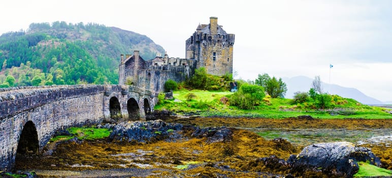 Panoramic view of famous Eilean Donan Castle in Scotland, UK. Situated on a small isle at the meeting point of three sea lochs - Loch Long, Loch Duich and Loch Alsh, is one of the most iconic images of Scotland.
