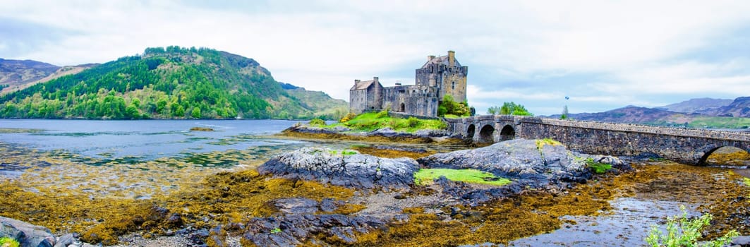 Panoramic view of famous Eilean Donan Castle in Scotland, UK. Situated on a small isle at the meeting point of three sea lochs - Loch Long, Loch Duich and Loch Alsh, is one of the most iconic images of Scotland.